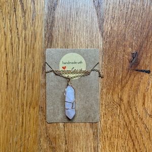 Light pink crystal necklace with gold chain.